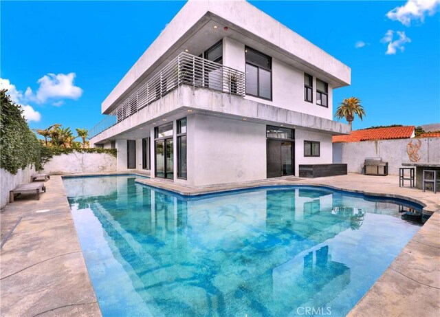 205 Esplanade, San Clemente, CA 92672 - back of property with a patio area, fence, a fenced in pool, a balcony, and stucco siding