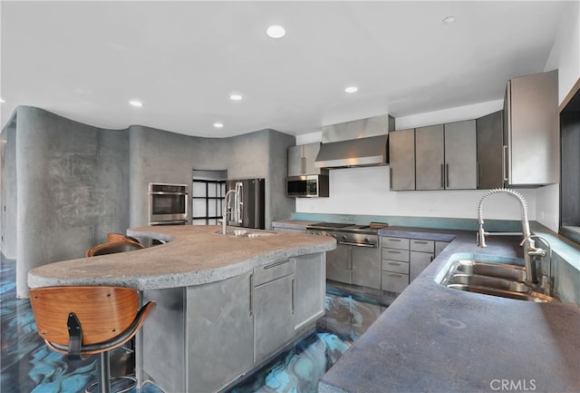 205 Esplanade, San Clemente, CA 92672 - kitchen featuring wall chimney exhaust hood, appliances with stainless steel finishes, recessed lighting, an island with sink, and a breakfast bar area