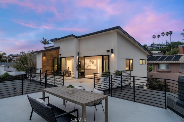 4414 Monaco St, San Diego, CA 92107 - back of house at dusk featuring a patio, stucco siding, and a balcony