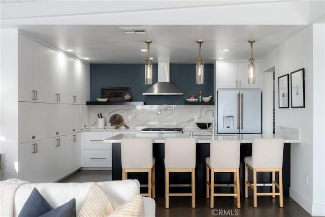 4414 Monaco St, San Diego, CA 92107 - kitchen featuring wall chimney range hood, high quality fridge, light countertops, a kitchen bar, and recessed lighting