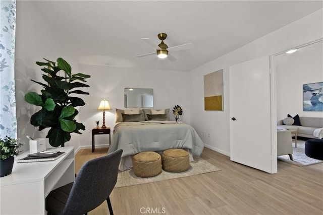 bedroom with light wood finished floors and baseboards