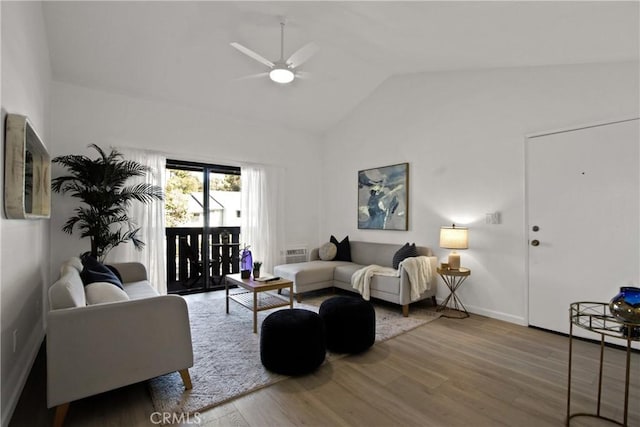 living room featuring a ceiling fan, lofted ceiling, baseboards, and wood finished floors