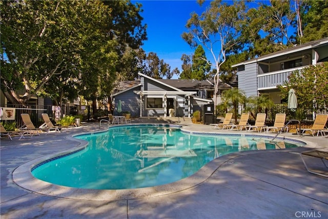 pool featuring a patio area and fence