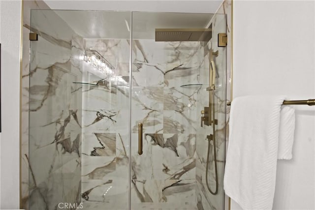 bathroom with a marble finish shower