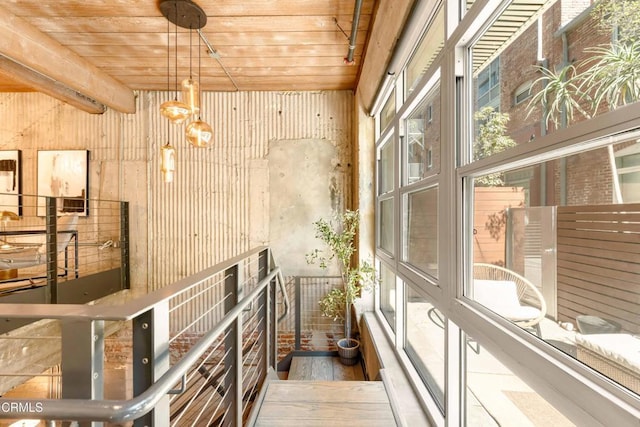 interior space featuring beamed ceiling, wood ceiling, and an inviting chandelier