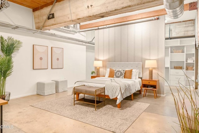 bedroom with baseboards and concrete flooring