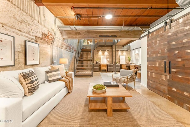 interior space with wood ceiling, a barn door, and stairs