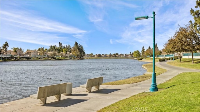 view of community with a water view and a lawn