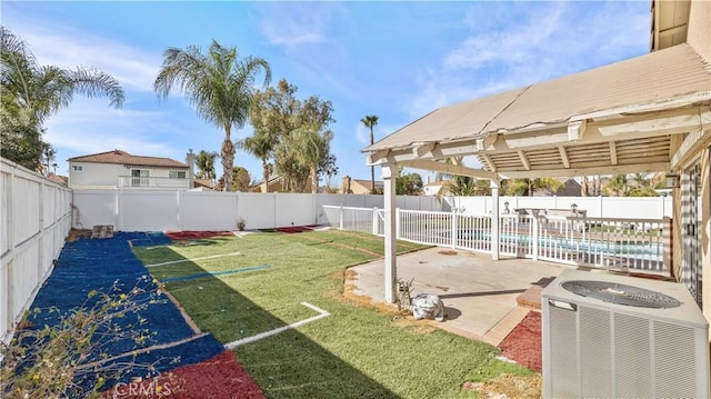 view of yard featuring central AC unit, a patio area, a fenced backyard, and a pool