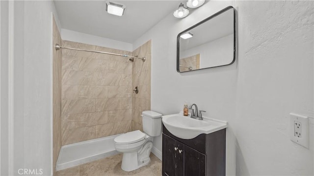 full bath with tiled shower, vanity, toilet, and tile patterned floors