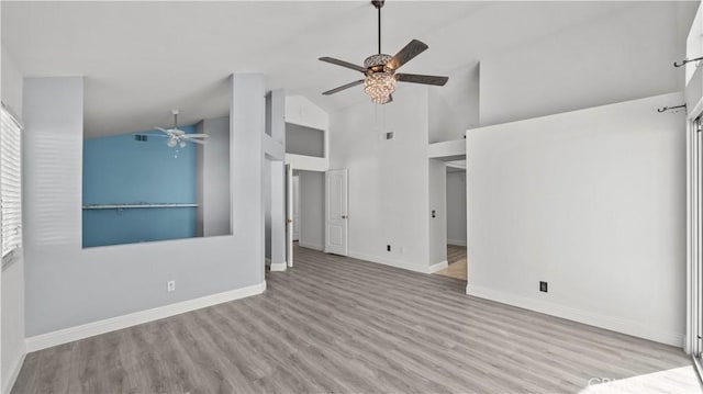 unfurnished room with light wood-style floors, high vaulted ceiling, baseboards, and a ceiling fan