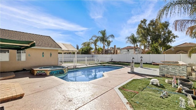 view of swimming pool featuring a pool with connected hot tub, a fenced backyard, and a patio