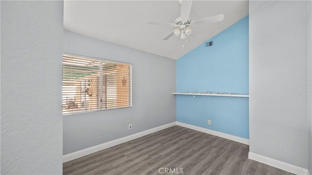 unfurnished room with baseboards, visible vents, vaulted ceiling, and wood finished floors