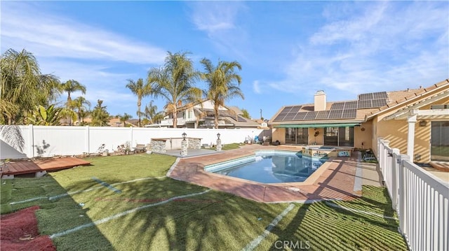 view of swimming pool with a yard, a fenced backyard, and a pool with connected hot tub