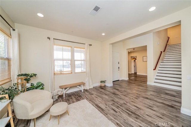 sitting room with stairs, visible vents, wood finished floors, and recessed lighting