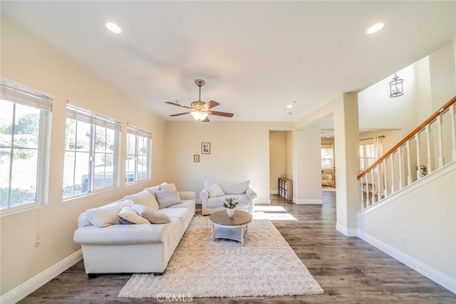 living room with recessed lighting, dark wood-type flooring, ceiling fan, baseboards, and stairs