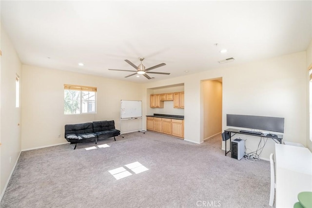 living area with light carpet, baseboards, visible vents, and ceiling fan