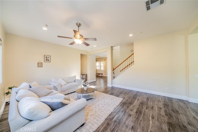 living room featuring baseboards, visible vents, stairway, dark wood-style flooring, and recessed lighting