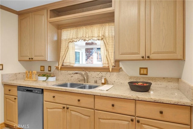 kitchen with light brown cabinets, stainless steel dishwasher, and a sink