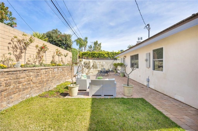 view of yard with a patio area and a fenced backyard