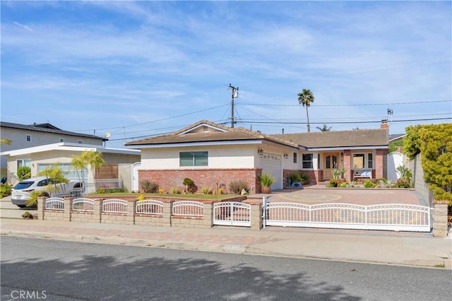 ranch-style home featuring driveway, brick siding, a fenced front yard, and an attached garage