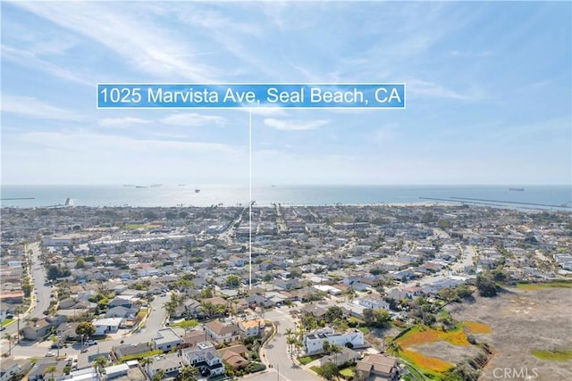 birds eye view of property with a water view and a residential view