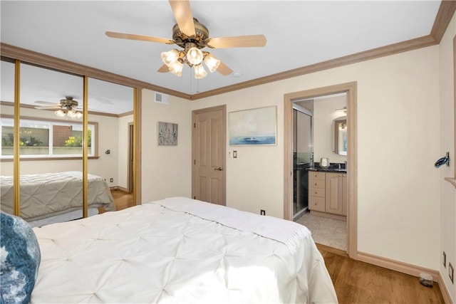 bedroom featuring a ceiling fan, baseboards, visible vents, light wood-style floors, and crown molding