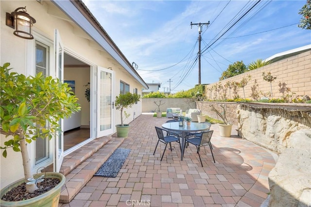 view of patio with outdoor dining space and a fenced backyard