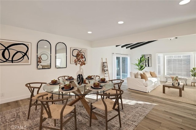 dining area featuring baseboards, wood finished floors, and recessed lighting