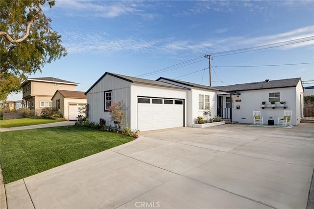 ranch-style house featuring a garage, concrete driveway, and a front lawn