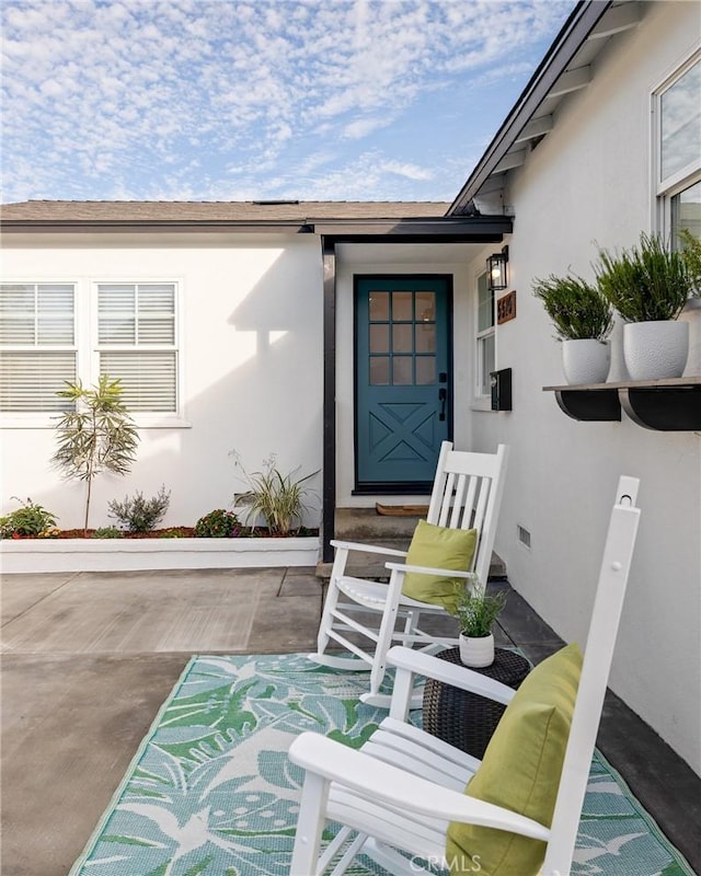 entrance to property with stucco siding