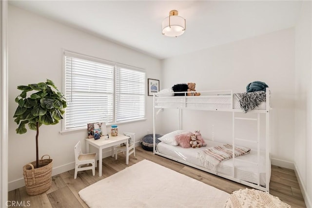 bedroom featuring wood finished floors and baseboards