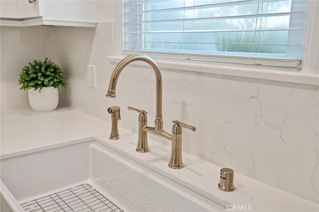 details with white cabinets and a sink