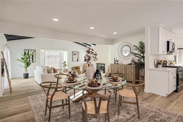 dining space featuring light wood-style floors, baseboards, and recessed lighting