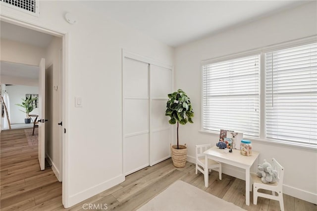 interior space featuring light wood-style floors, visible vents, and plenty of natural light