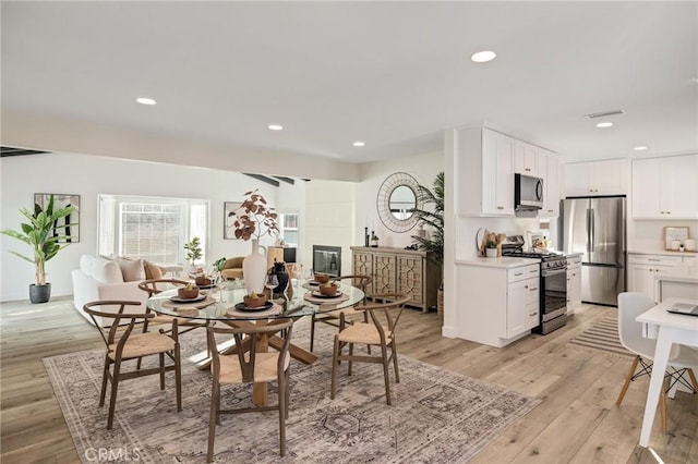 dining space featuring recessed lighting, visible vents, and light wood finished floors