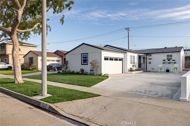 view of front of property featuring a front lawn, driveway, and an attached garage