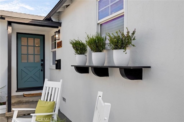 doorway to property with stucco siding