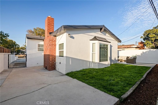 back of property featuring a patio, fence, an outdoor living space, a yard, and stucco siding