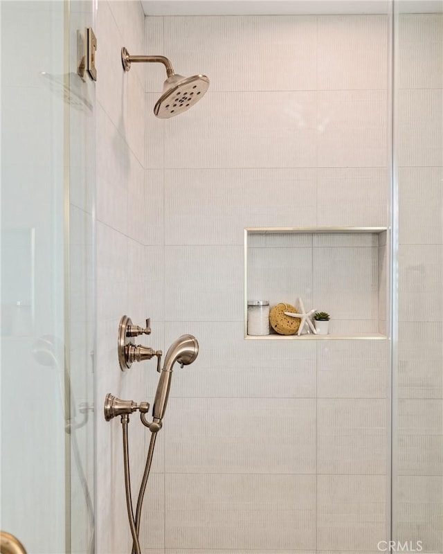 interior details featuring a tile shower