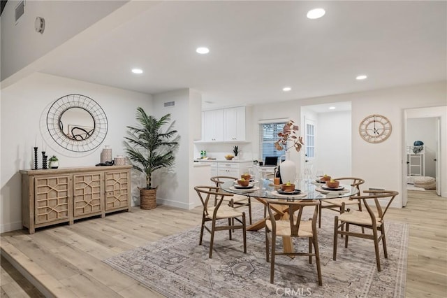 dining space featuring light wood-style floors, visible vents, baseboards, and recessed lighting