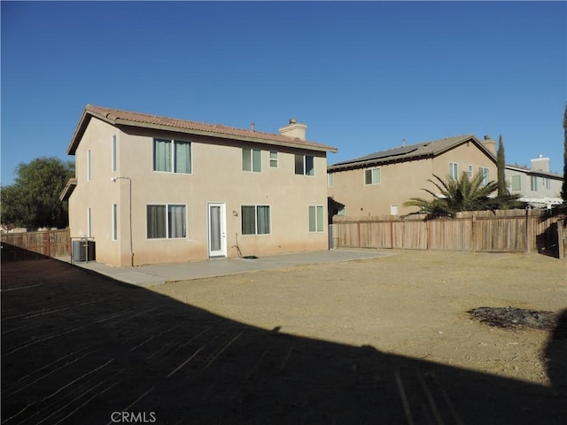 rear view of property featuring a patio area, fence, cooling unit, and stucco siding