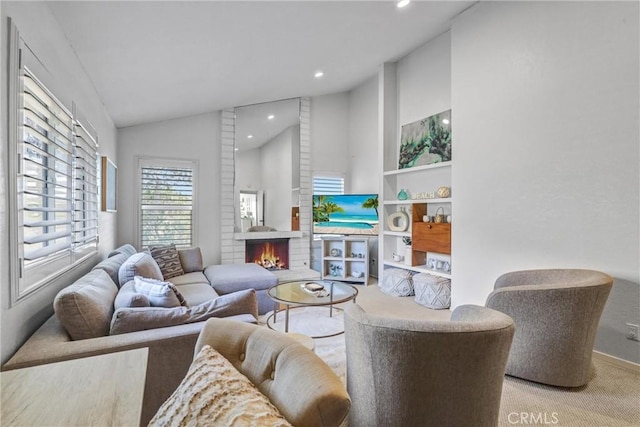 living area featuring vaulted ceiling, carpet floors, a brick fireplace, and recessed lighting