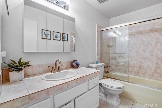 full bath with toilet, tile patterned floors, combined bath / shower with glass door, and vanity