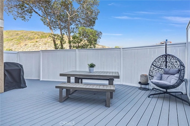 wooden terrace with area for grilling and fence