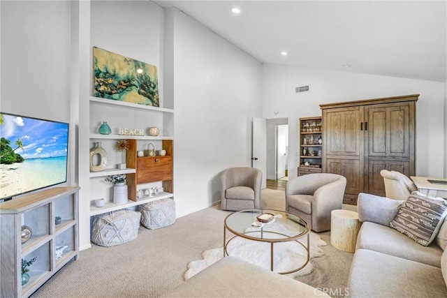 carpeted living area with high vaulted ceiling, recessed lighting, and visible vents