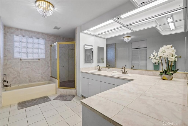 full bath with a stall shower, a sink, visible vents, and tile patterned floors