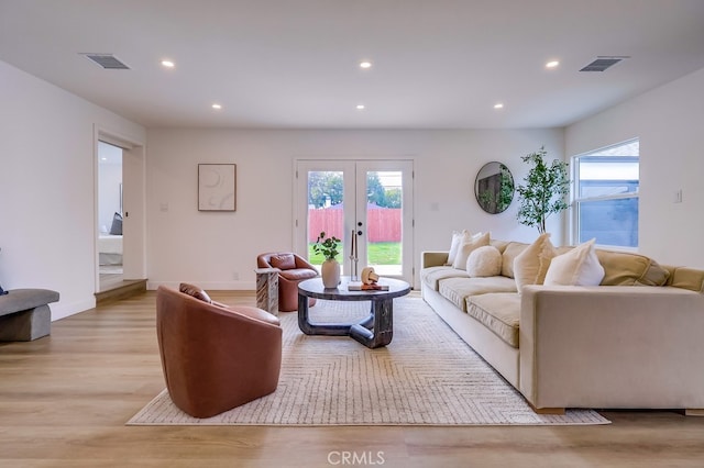 living room with light wood-style floors, recessed lighting, visible vents, and plenty of natural light