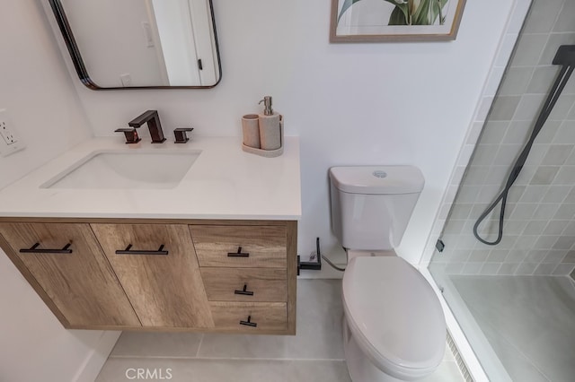 full bath featuring toilet, tiled shower, and vanity