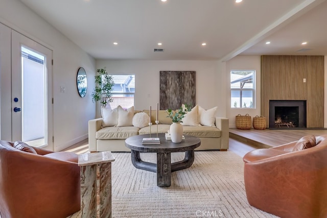 living area featuring a healthy amount of sunlight, a fireplace, visible vents, and recessed lighting